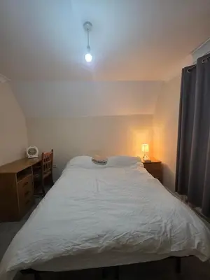 a bedroom with a large white bed and a desk at Cozy Guest Room in Colchester - Perfect for Travelers in Colchester