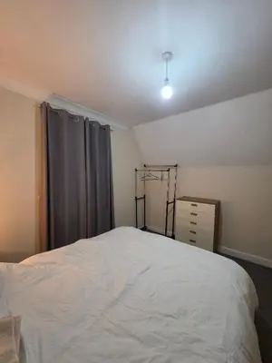 a bedroom with a white bed and a window at Cozy Guest Room in Colchester - Perfect for Travelers in Colchester