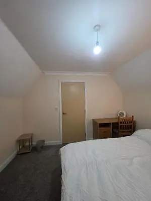 a bedroom with a bed and a desk and a door at Cozy Guest Room in Colchester - Perfect for Travelers in Colchester