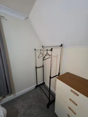 a room with a stand in the corner of a room at Cozy Guest Room in Colchester - Perfect for Travelers in Colchester