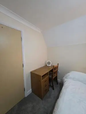 a bedroom with a desk next to a bed and a bed sqor at Cozy Guest Room in Colchester - Perfect for Travelers in Colchester