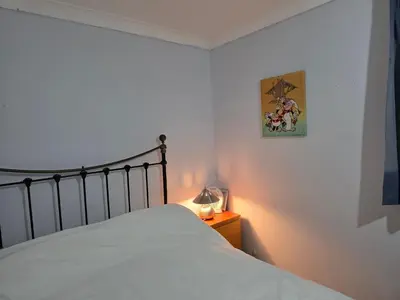a bedroom with a bed and a lamp on a night stand at Guest Room in Colchester Hythe in Colchester