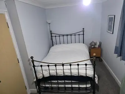 a small bed in a corner of a room at Guest Room in Colchester Hythe in Colchester