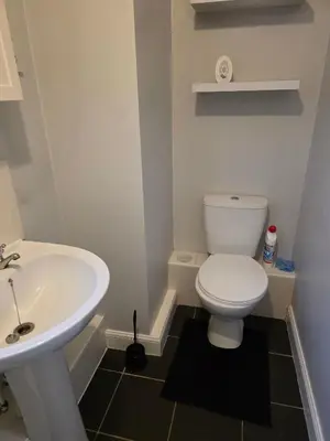 a bathroom with a white toilet and a sink at Near Colcheste town centre in Colchester