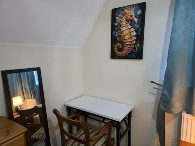 a room with a table and a mirror on the wall at Charming Colchester Room with Garden Views in Colchester