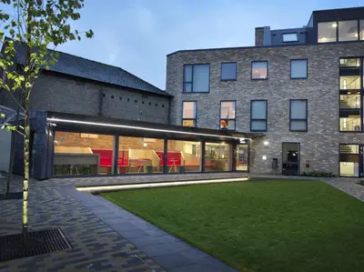 a large brick building with a lawn in front of it at For Students Only - Student Castle Cambridge in Cambridge