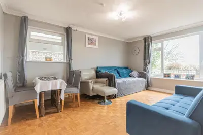 a living room with a couch and a table at Pass the Keys Seaside Escape 2-Bedroom Flat EastBeach sleeps 4 in Southend-on-Sea