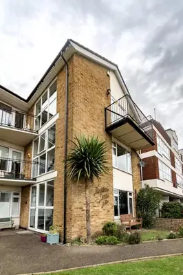 an apartment building with a staircase on the side of it at Pass the Keys Seaside Escape 2-Bedroom Flat EastBeach sleeps 4 in Southend-on-Sea