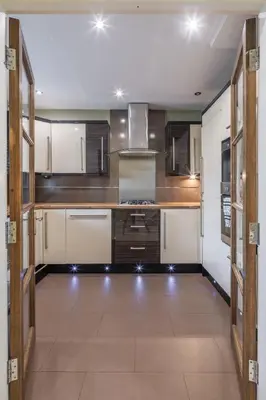 a large kitchen with wooden cabinets and appliances at 4 BR I 2 BA I Sleeps 8 I Spacious I Modern I Wi-Fi I in Cambridge