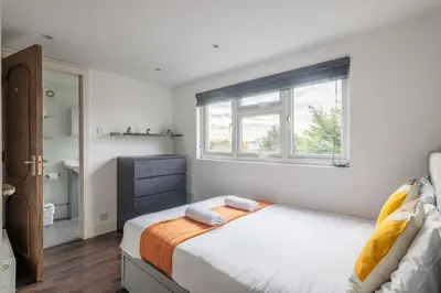 a bedroom with a bed with two towels on it at 4 BR I 2 BA I Sleeps 8 I Spacious I Modern I Wi-Fi I in Cambridge