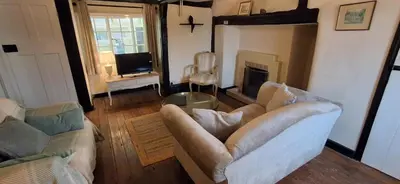 a living room with a couch and a fireplace at The Walnut Nook in Abbess Roding