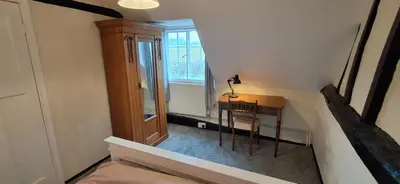 a small room with a table and a window at The Walnut Nook in Abbess Roding