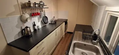 a kitchen with a sink and a counter top at The Walnut Nook in Abbess Roding