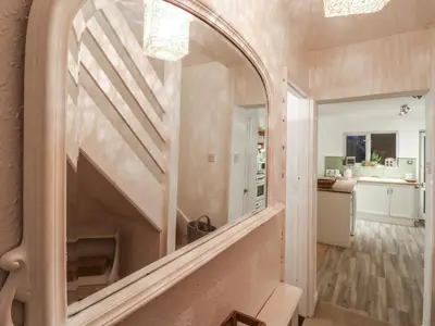 a hallway with a large mirror on the wall at Berkley Cottage in Colchester