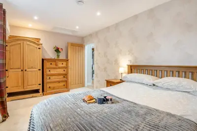 a bedroom with a bed with a dresser and two mugs on it at 1 Bed in Dickleburgh oc-m33974 in Dickleburgh