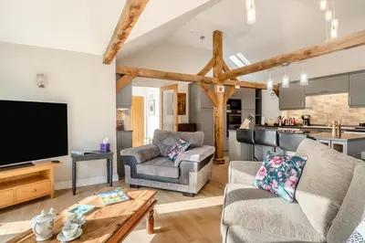 a living room with a couch and a tv at 1 Bed in Dickleburgh oc-m33974 in Dickleburgh