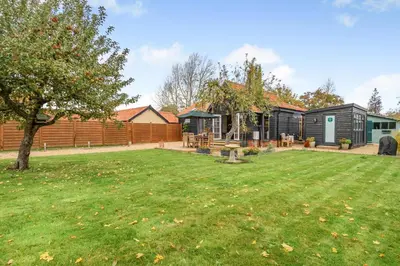 a garden with a house and a yard at 1 Bed in Dickleburgh oc-m33974 in Dickleburgh