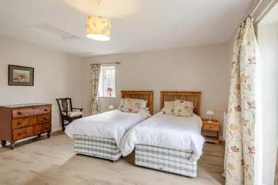 a bedroom with two beds and a dresser at 2 Bed in Bressingham oc-f33646 in Bressingham
