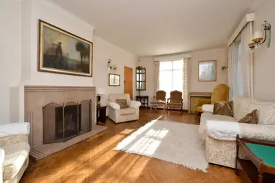 a living room with a fireplace and a table at Period Family House by the Beach in Walton-on-the-Naze