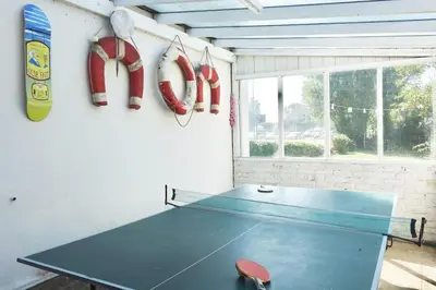 a ping pong table in a room with a ping pong at Period Family House by the Beach in Walton-on-the-Naze