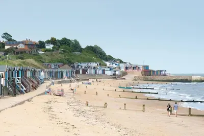 a beach with people and boats in the water at Period Family House by the Beach in Walton-on-the-Naze