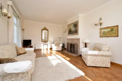 a living room with two couches and a fireplace at Period Family House by the Beach in Walton-on-the-Naze