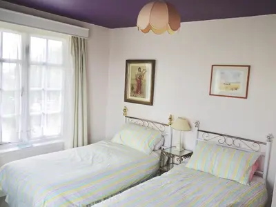 two beds sitting next to each other in a bedroom at Period Family House by the Beach in Walton-on-the-Naze
