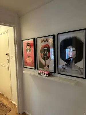 a row of four pictures on a shelf on a wall at Stylish One Bedroom Apartment in Central Potton in Potton