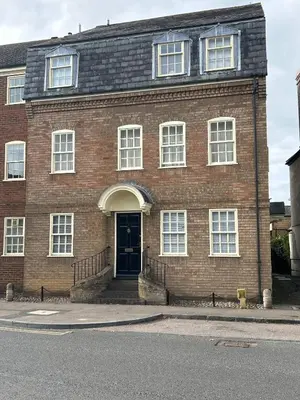 a red brick building with a blue door at Stylish One Bedroom Apartment in Central Potton in Potton