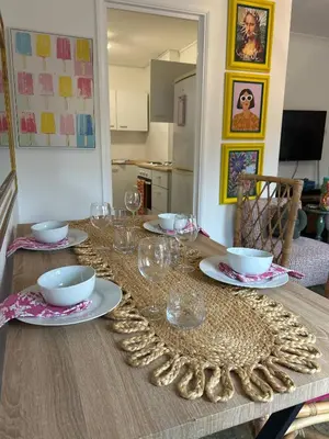 a table with glasses and plates on top of it at Stylish One Bedroom Apartment in Central Potton in Potton