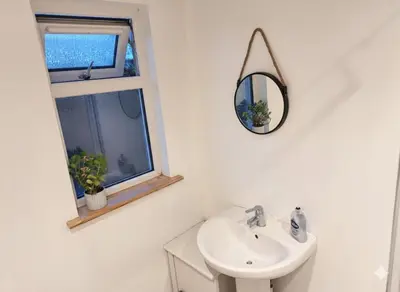 a bathroom with a sink and a mirror and a window at Modern 4BR Cambridge House with Parking for 9 guests in Cambridge