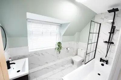 a white bathroom with a tub and a toilet and a sink at 5 The Royal Serviced Apartments Harwich, Private Parking, Fast Wifi in Parkeston