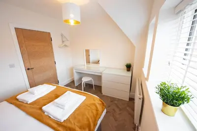 a small bedroom with a bed and a desk at 5 The Royal Serviced Apartments Harwich, Private Parking, Fast Wifi in Parkeston