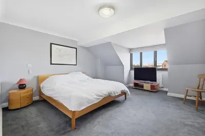a white bedroom with a bed and a tv at Four Bed House by Brookland Stays Serviced Accommodation Short Lets Brentwood with Free WiFi