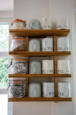 a shelf full of cups and mugs in a kitchen at The Manor Dairy in Sandy