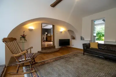 a living room with a couch and a chair at The Manor Dairy in Sandy