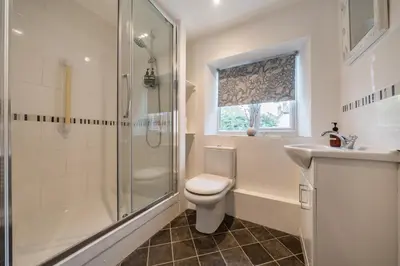 a bathroom with a shower and a toilet and a sink at Bridewell Lane, Bury St Edmunds, Suffolk in Bury Saint Edmunds