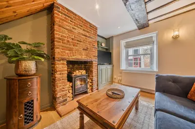 a living room with a brick fireplace at Bridewell Lane, Bury St Edmunds, Suffolk in Bury Saint Edmunds
