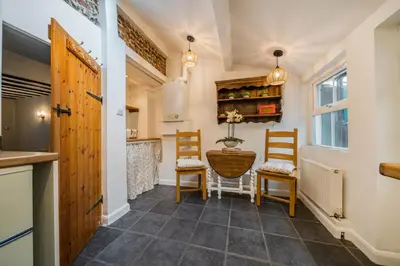 a kitchen with two chairs and a table in a room at Bridewell Lane, Bury St Edmunds, Suffolk in Bury Saint Edmunds