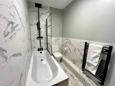 a white bathroom with a sink and a toilet at 3 The Royal Serviced Apartments, Harwich -Ground Floor-Parking -Wifi in Parkeston