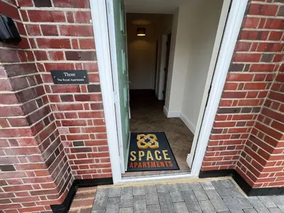 a sign in the doorway of a building at 3 The Royal Serviced Apartments, Harwich -Ground Floor-Parking -Wifi in Parkeston