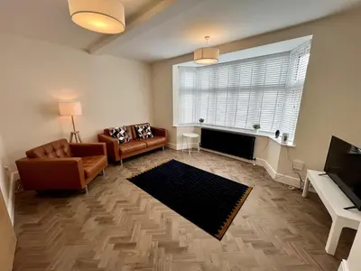 a living room with a couch and a fireplace at 3 The Royal Serviced Apartments, Harwich -Ground Floor-Parking -Wifi in Parkeston