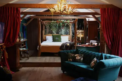 a living room with a bed and a couch at Hollow Heath in Layer de la Haye