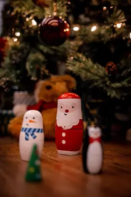 three miniature santa claus figurines in front of a christmas tree at Hollow Heath in Layer de la Haye