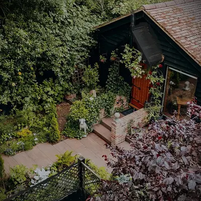 an overhead view of a garden with plants and a wooden door at Hollow Heath in Layer de la Haye