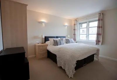 a bedroom with a large bed and a window at Toothbrush Apartments - Central Ipswich St Peters St in Ipswich
