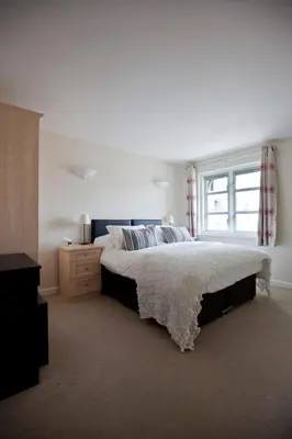 a bedroom with a large bed and a window at Toothbrush Apartments - Central Ipswich St Peters St in Ipswich