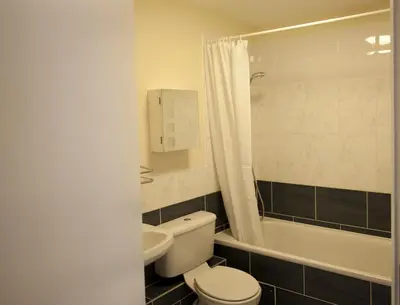 a bathroom with a toilet and a tub and a sink at Toothbrush Apartments - Central Ipswich St Peters St in Ipswich