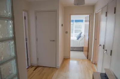 a hallway with a door leading to a bedroom at Toothbrush Apartments - Central Ipswich St Peters St in Ipswich