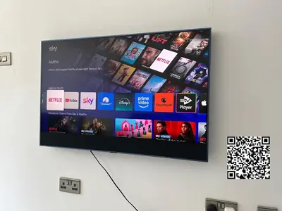 a flat screen tv hanging on a wall at Spacious 4 Bed house Perfect for Contractors-Relocators in Harlow